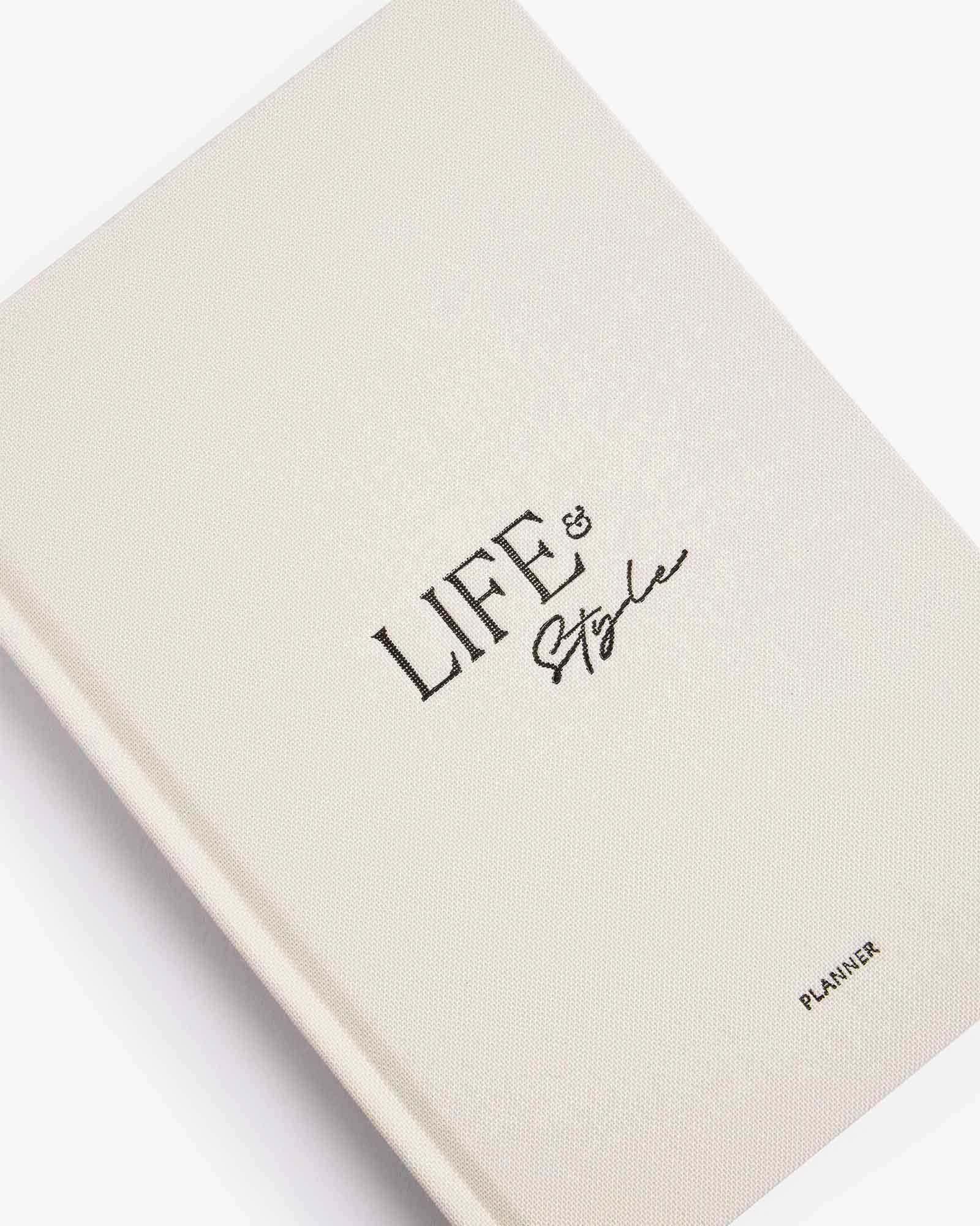 Beige planner with 'LIFE & Style' text on a white background