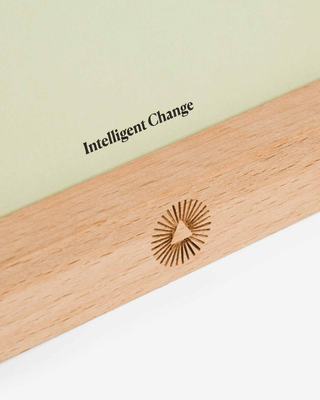 Wooden paddle with 'Intelligent Change' branding on a light background