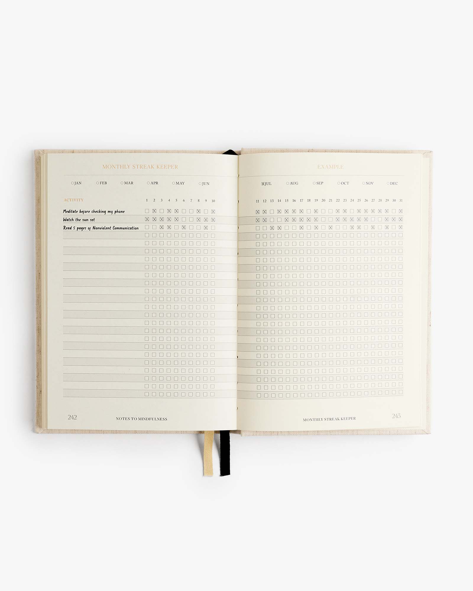 Open notebook with grid and checklist pages on a white background