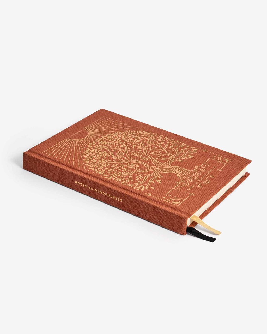 Brown notebook with decorative tree design on a white background