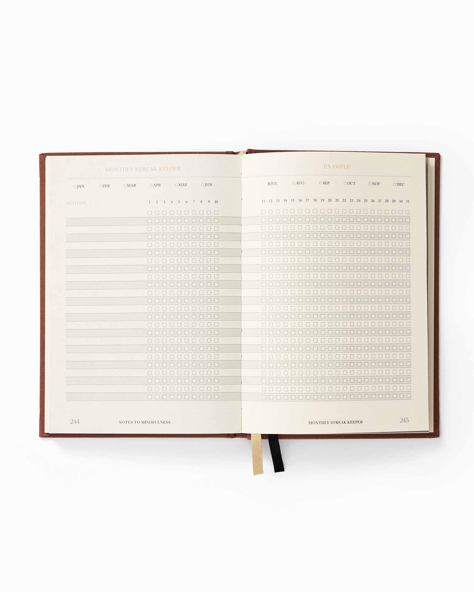 Open planner with monthly layout on a white background