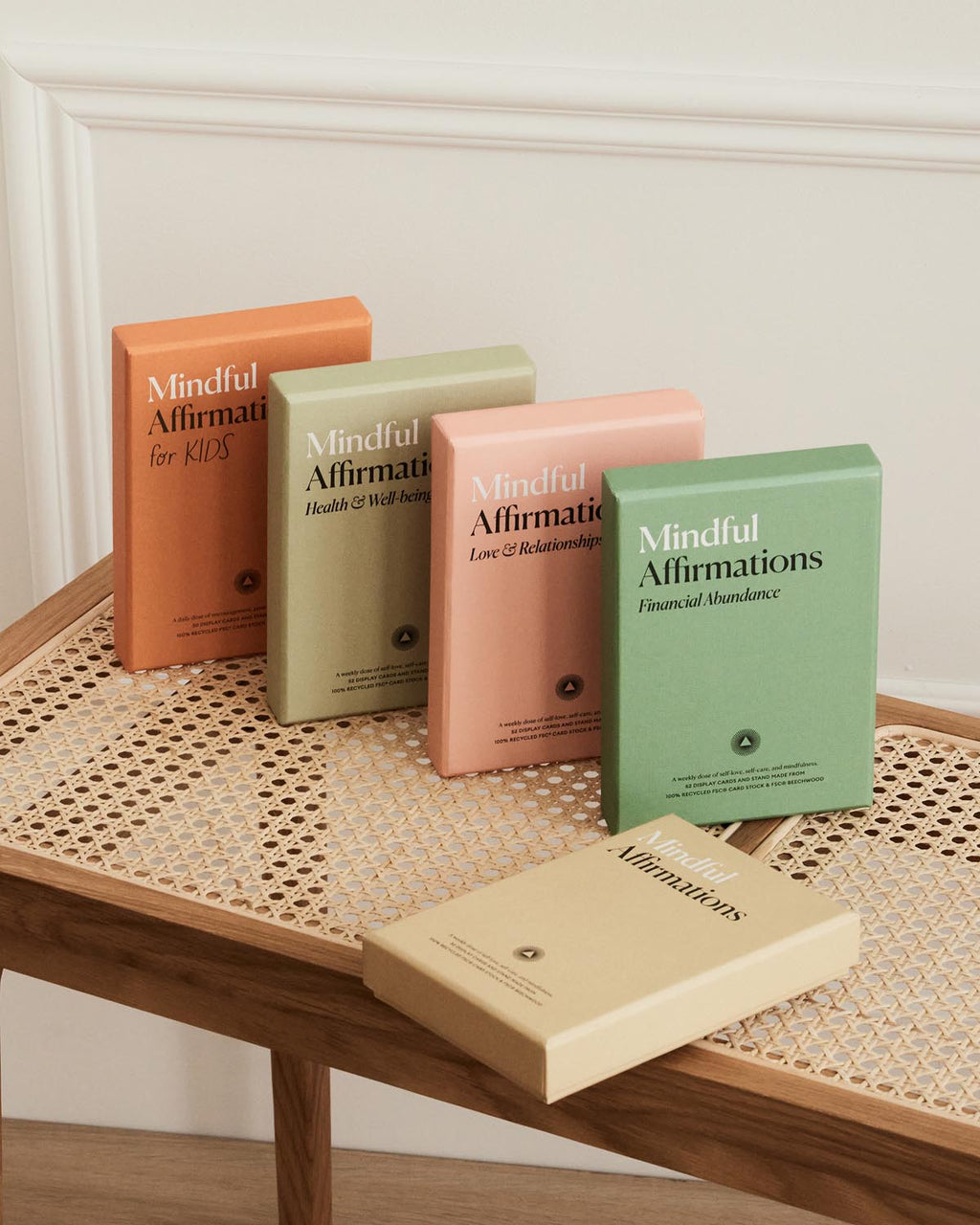 Five books titled 'Mindful Affirmations' on a wooden table with a neutral background