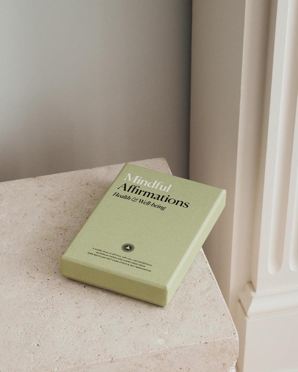 Green book titled 'Mindful Affirmations' on a surface with a neutral background