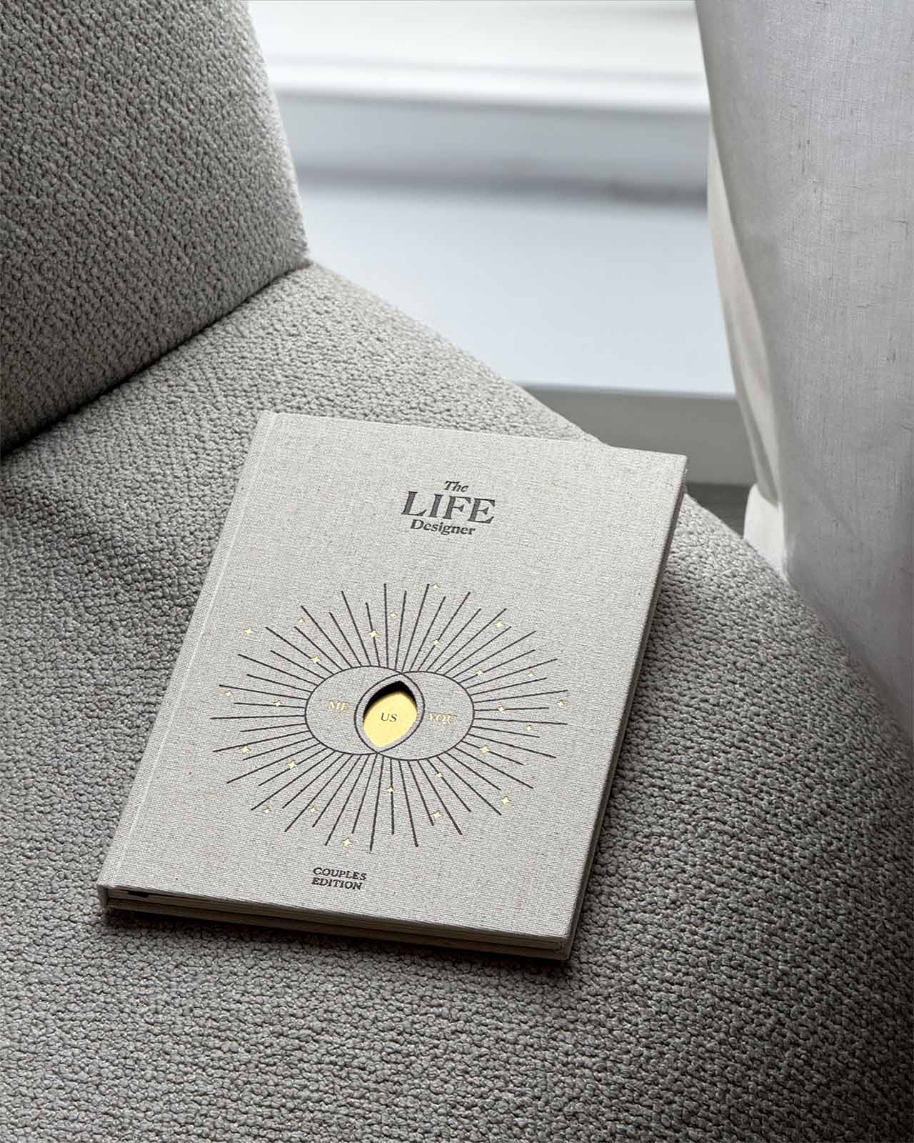 Book titled 'The Life Designer' on a textured surface