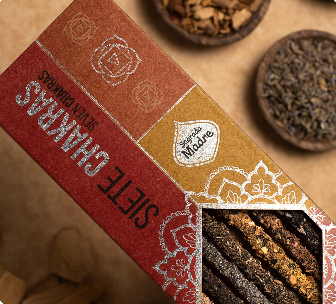 Box of Siete Chakras tea with tea leaves visible on a wooden surface