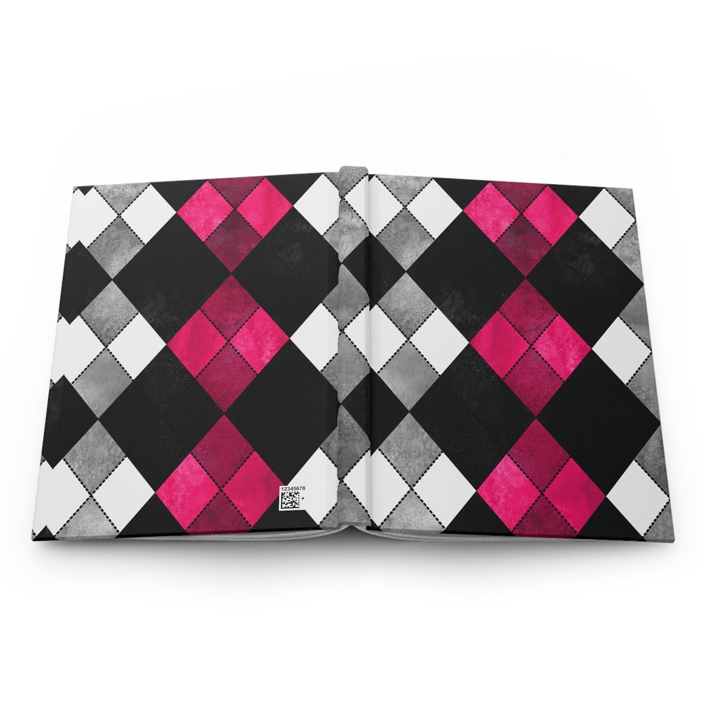 A hardcover notebook or journal shown open flat against a white background, featuring a bold argyle diamond pattern on the cover in black, gray, white, and vibrant magenta pink.