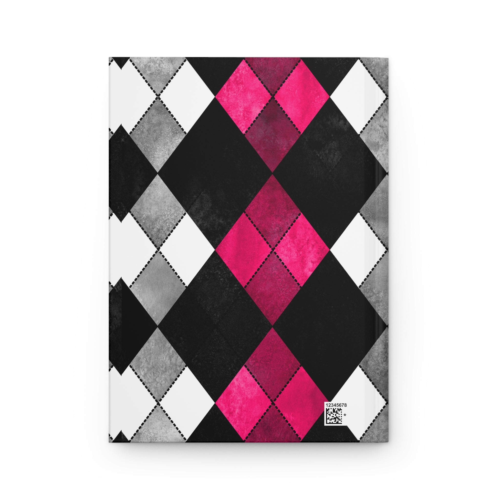 A notebook with a geometric argyle pattern cover featuring black, white, gray, and vibrant pink diamonds, shown on a plain white background.
