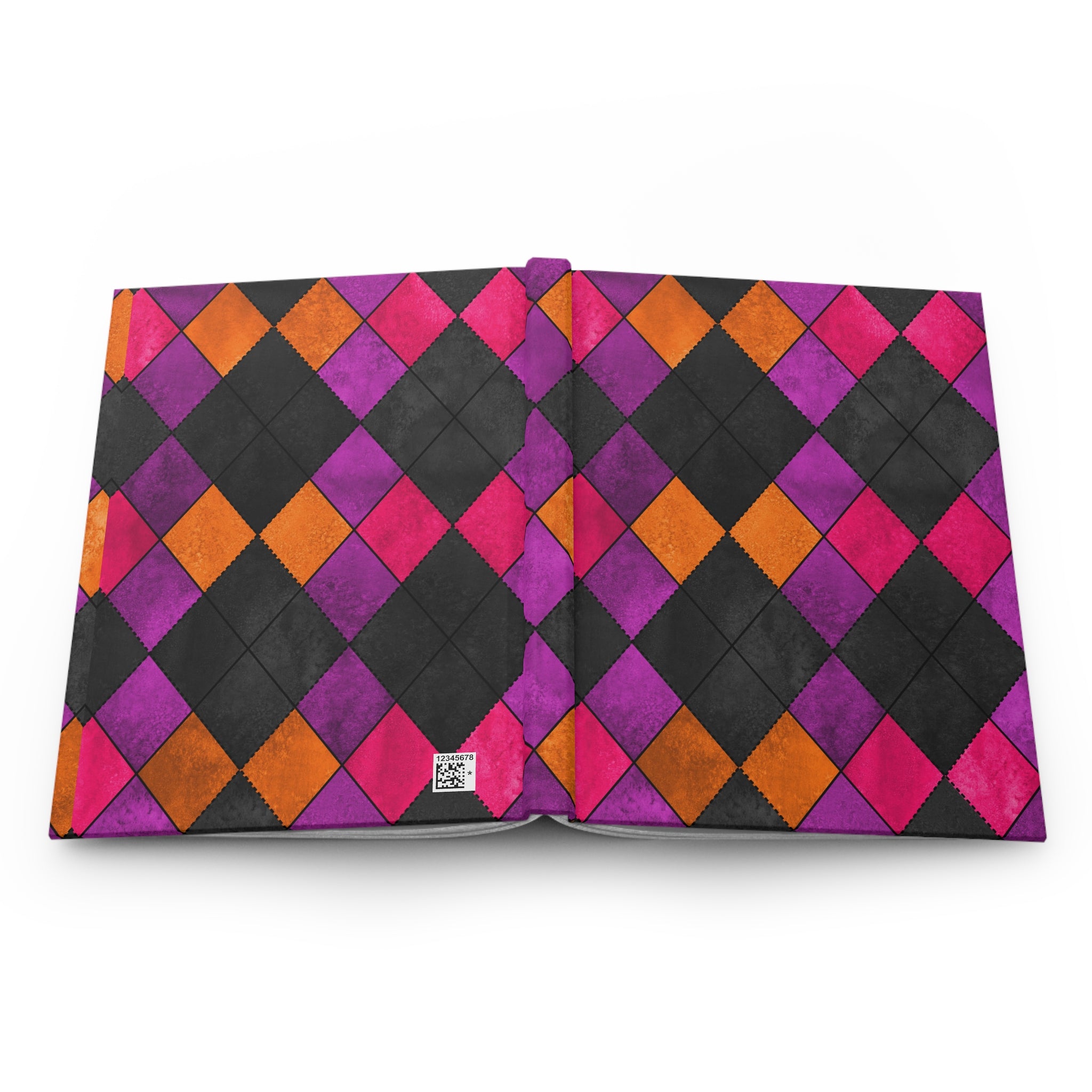 An open notebook or journal displaying a vibrant harlequin diamond pattern in black, magenta pink, purple, and orange on a clean white background.