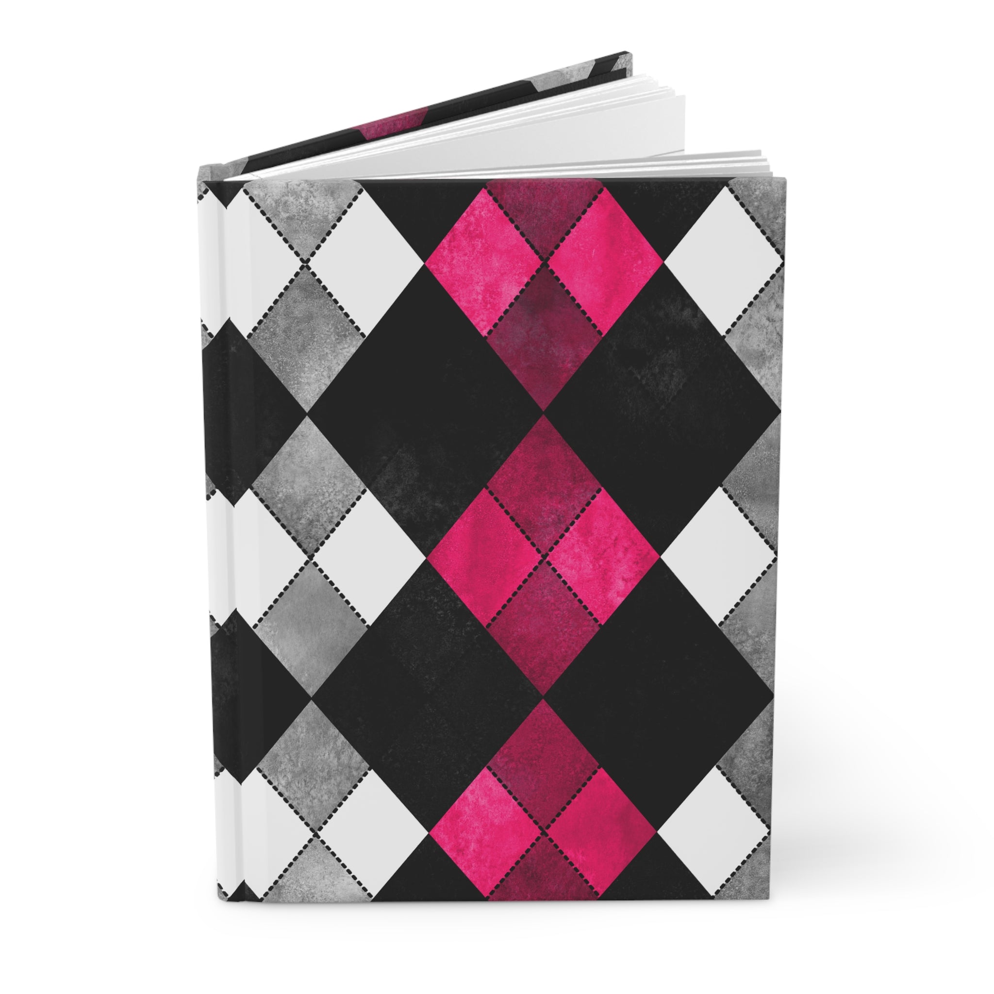 A hardcover notebook with a geometric argyle pattern in black, gray, white, and vibrant hot pink, shown open on a white background.