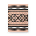 A notebook with a geometric tribal pattern in black and peach pink, shown on a clean white background.