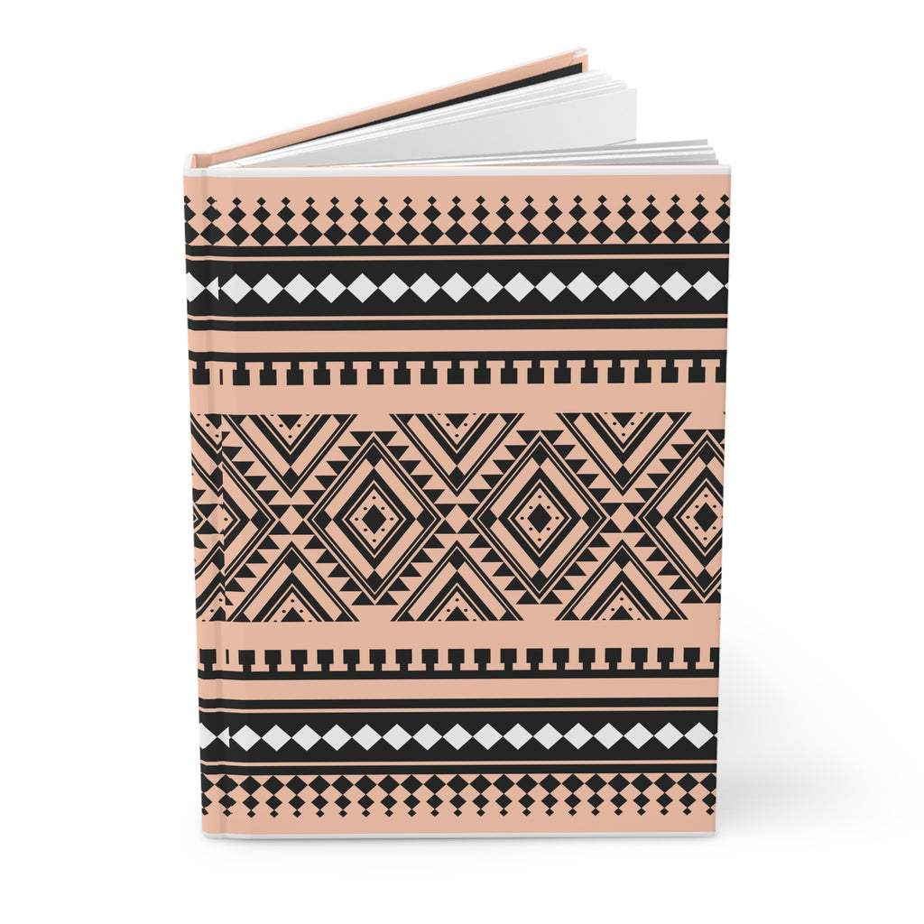 A hardcover notebook with a geometric Southwestern-style pattern in black and peach pink, featuring white accents, shown on a clean white background.