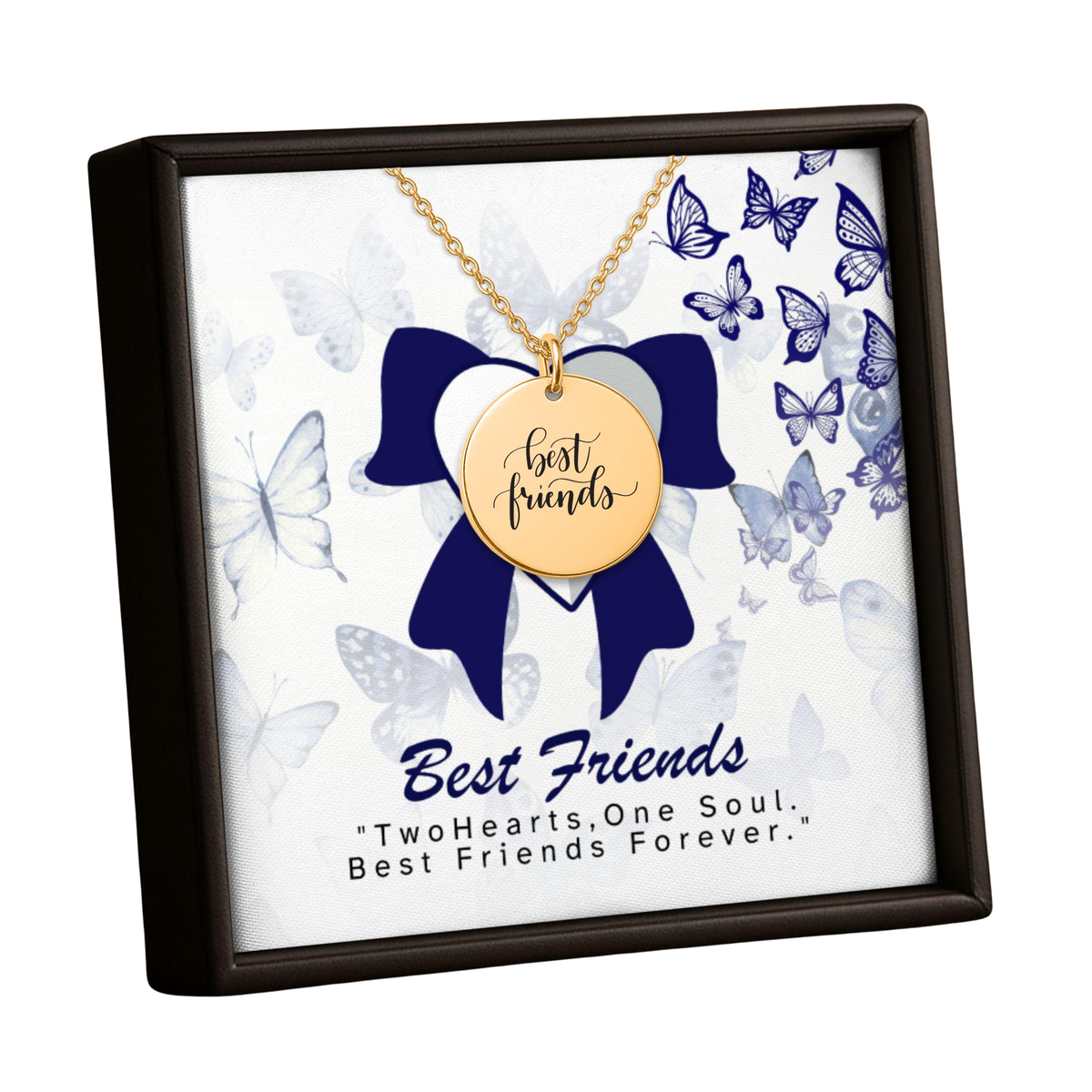 A gold-tone 'best friends' pendant necklace displayed inside a square presentation box with a dark brown frame. The necklace is suspended over a white insert decorated with blue butterflies and a large blue bow, with the text 'Best Friends' and 'TwoHearts, One Soul.