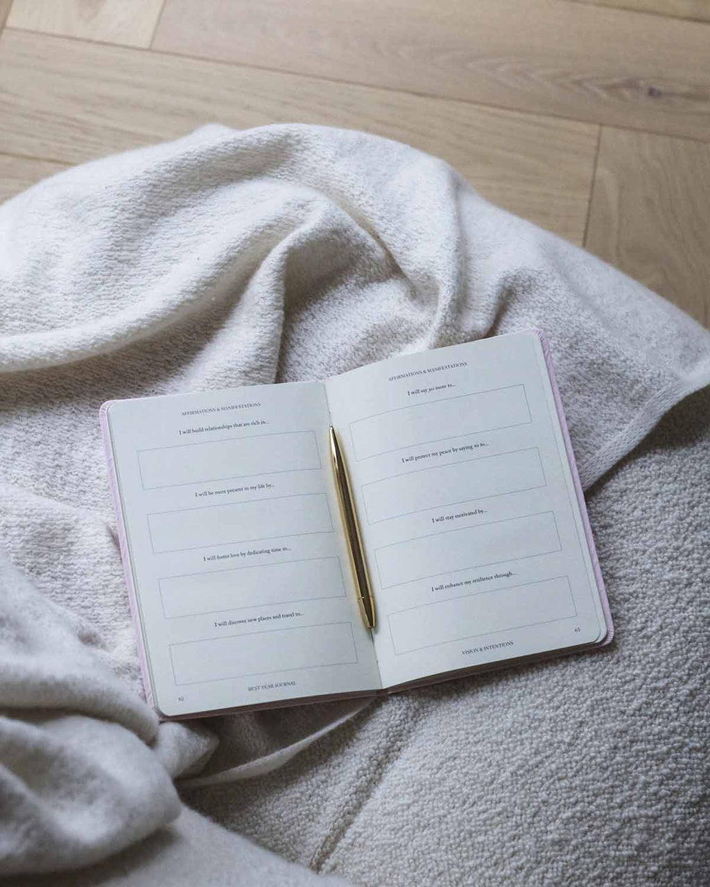 Open notebook with a pen on a soft fabric surface