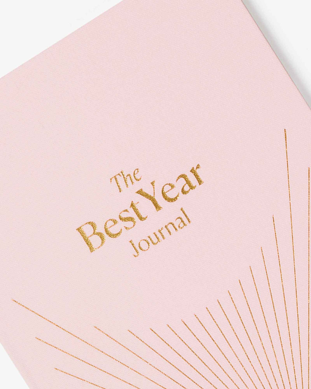 Pink journal with 'The Best Year Journal' text on a light background