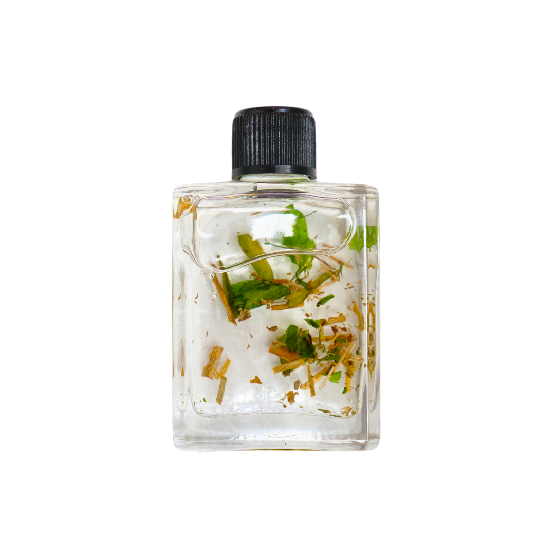 Small clear bottle with black cap containing herbs on a white background