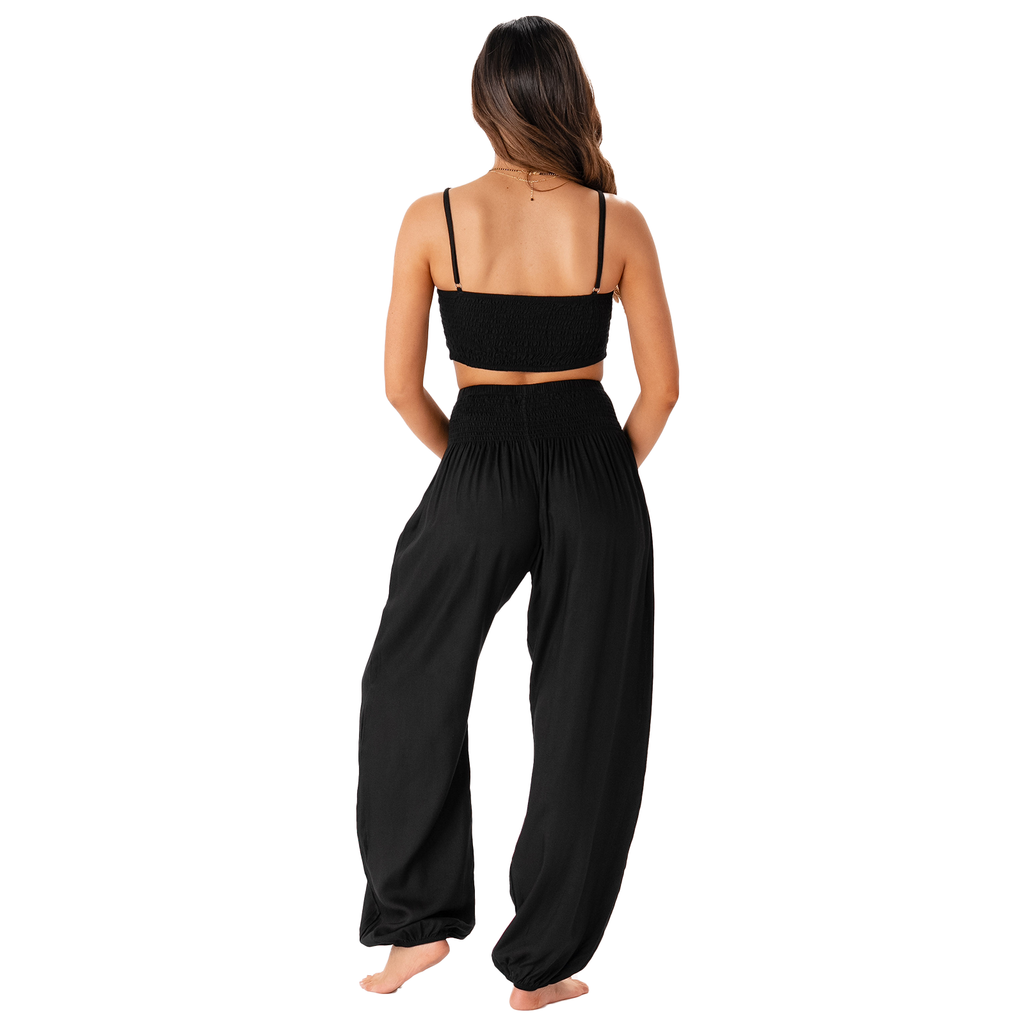 Woman wearing a black outfit on a white background