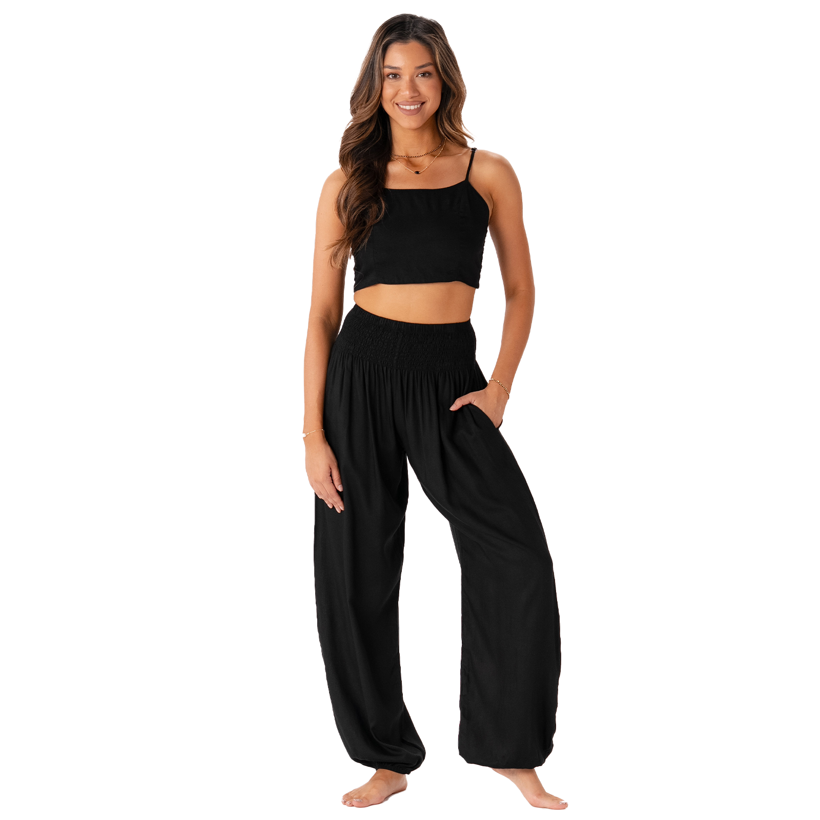 Woman wearing a black crop top and wide-leg pants on a white background