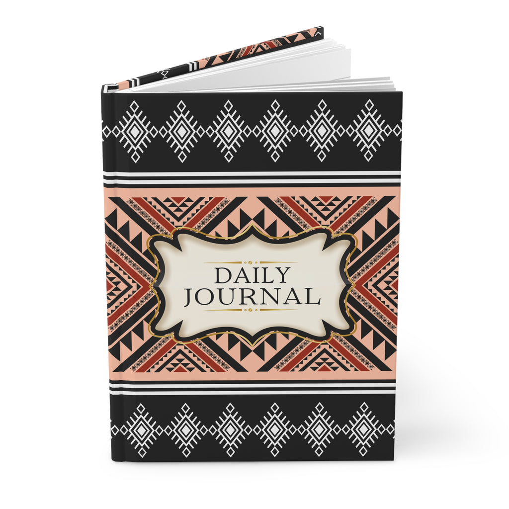 Black notebook with floral design and 'There Will Be Miracles' text on a white background
