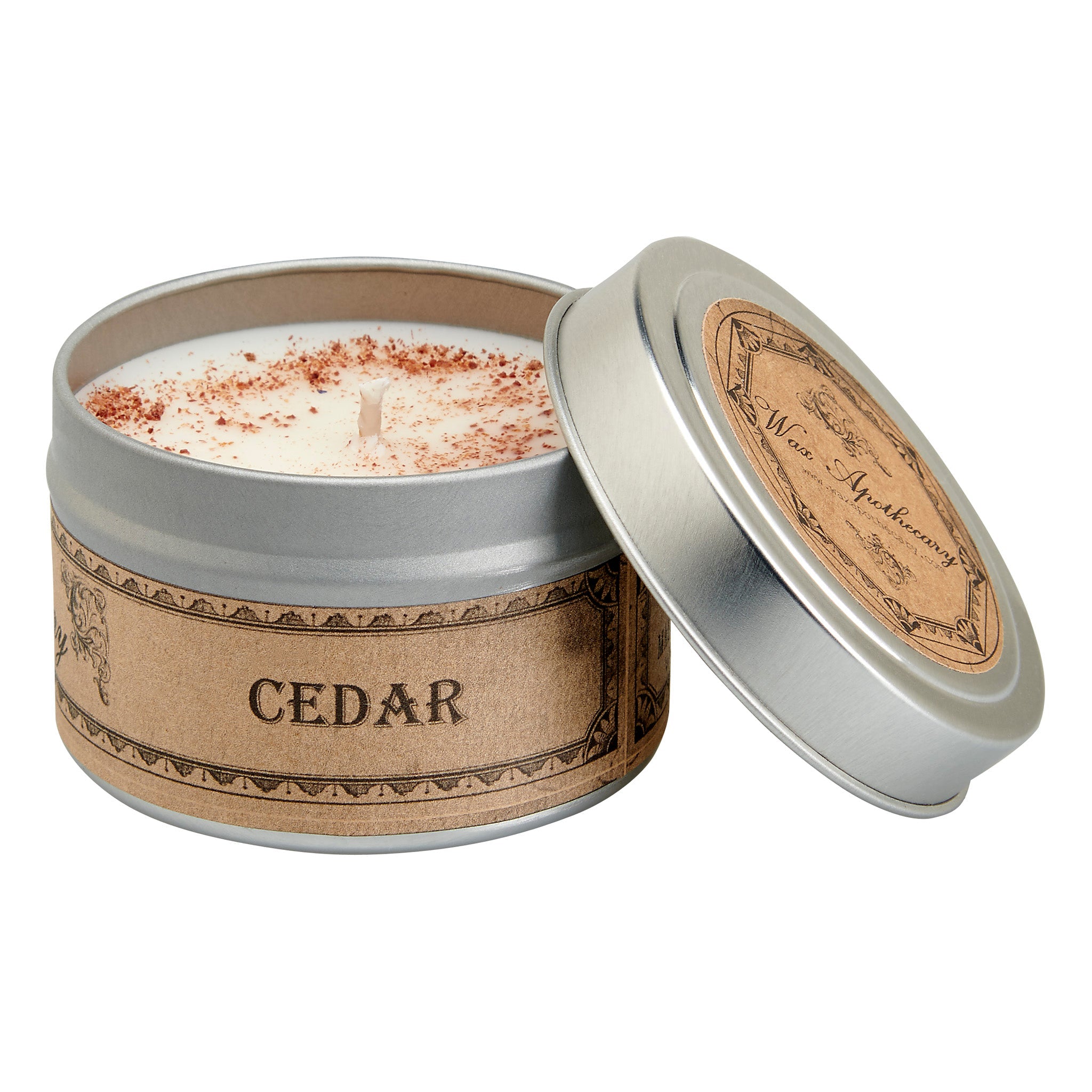 Candle in a tin labeled 'CEDAR' with a decorative lid on a white background