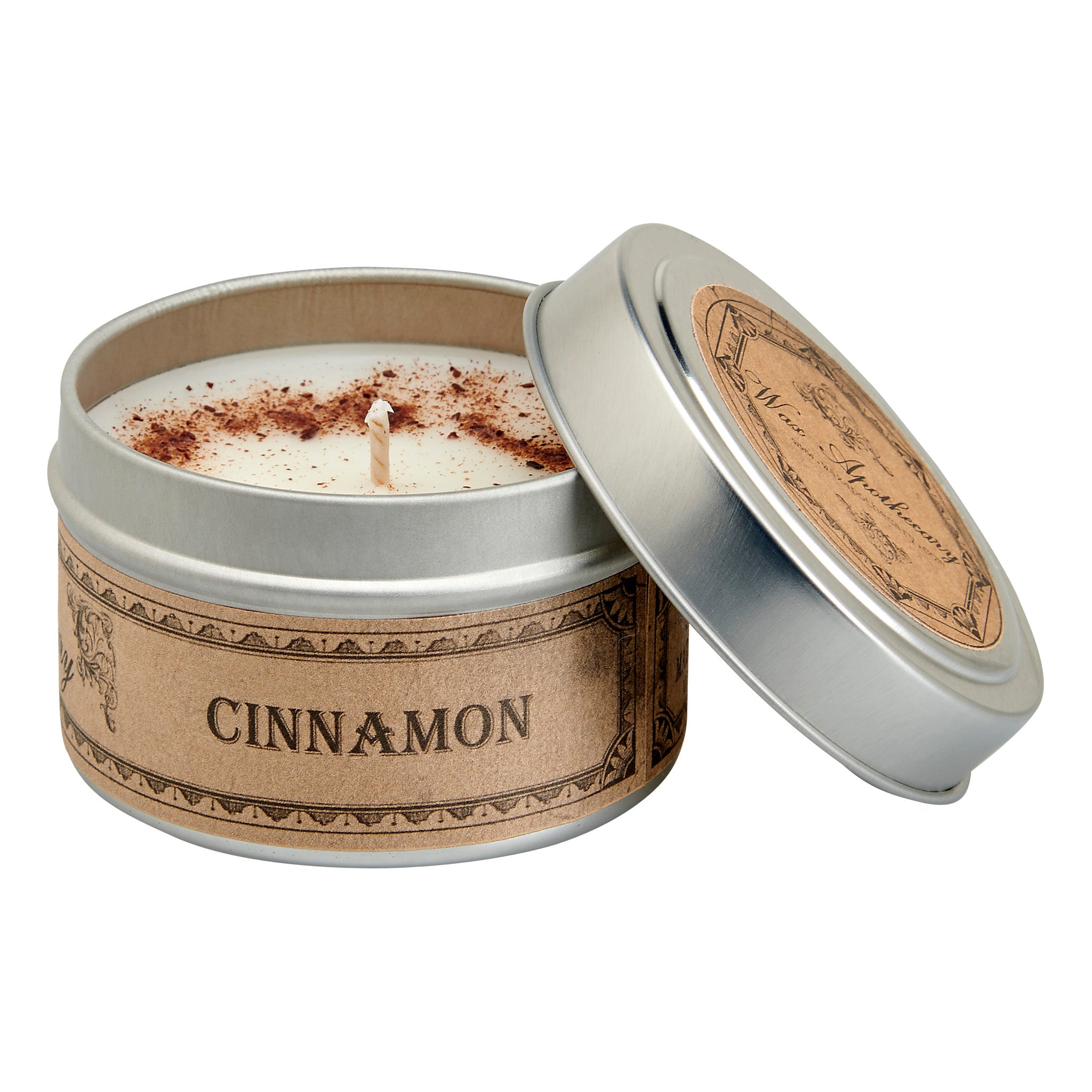 Candle in a tin labeled 'Cinnamon' with a decorative lid on a white background