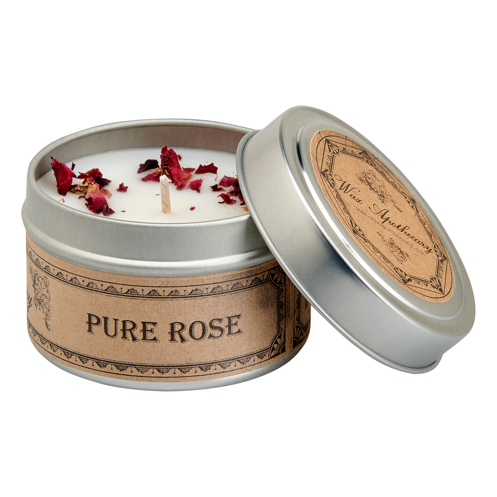 Candle in a tin labeled 'Pure Rose' with rose petals on a white background