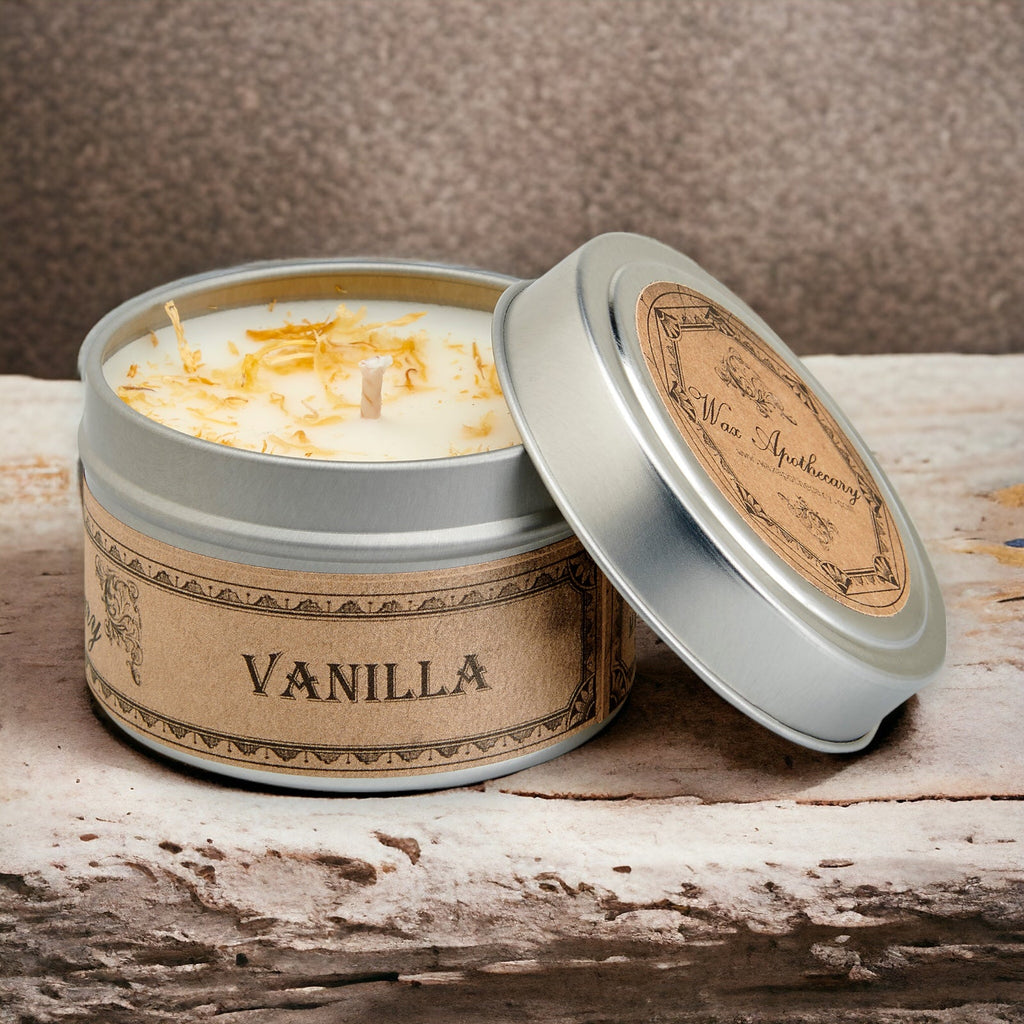 Vanilla scented candle in a tin with a wooden lid on a rustic surface