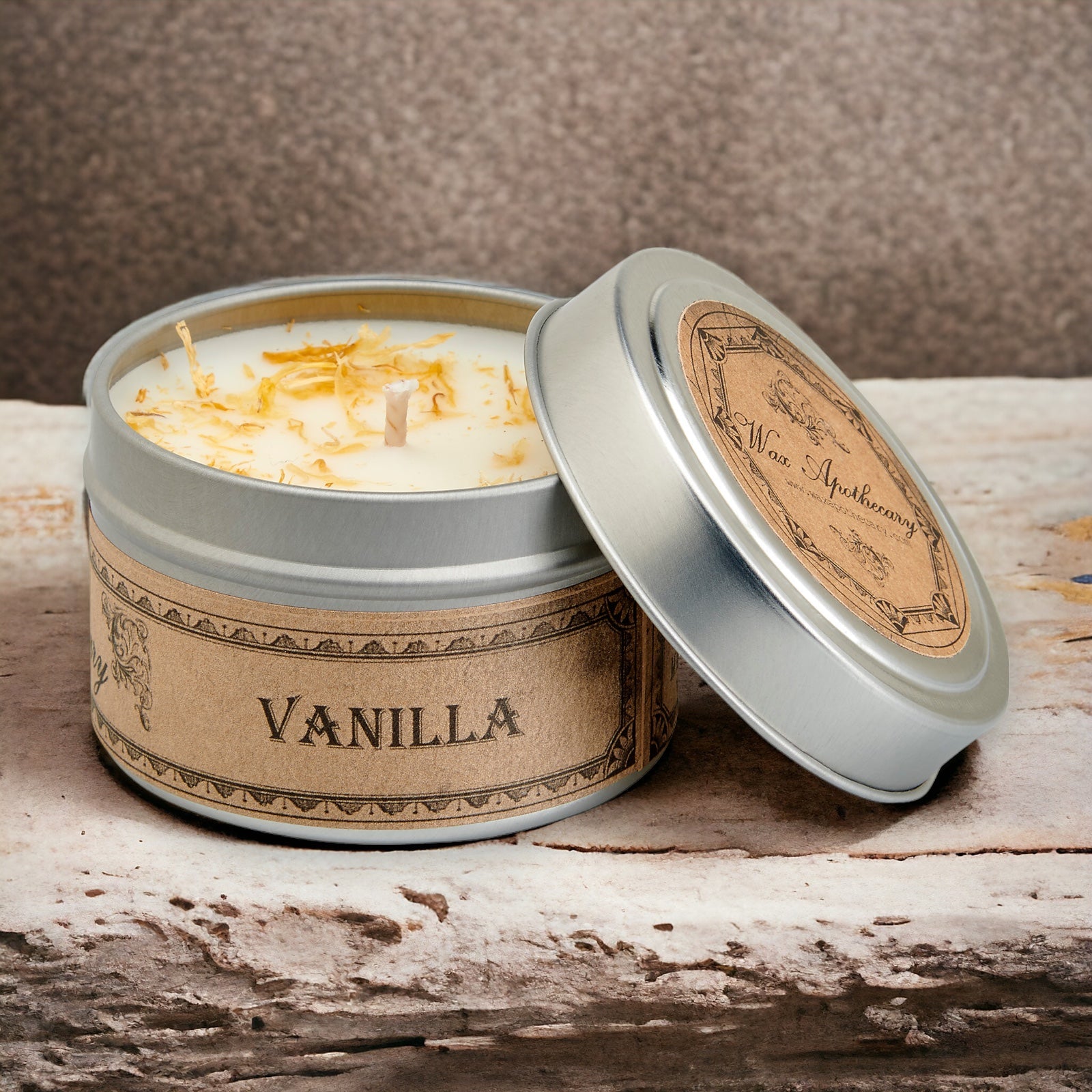 Vanilla scented candle in a tin with a wooden lid on a rustic surface
