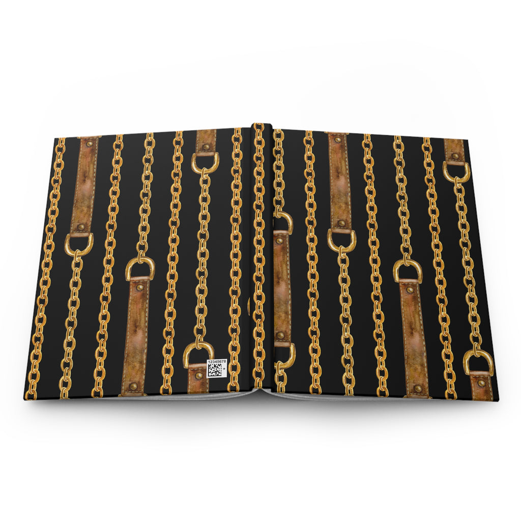 A book or notebook shown open flat against a white background, with a black cover printed with repeating vertical gold chains and brown leather-strap motifs.