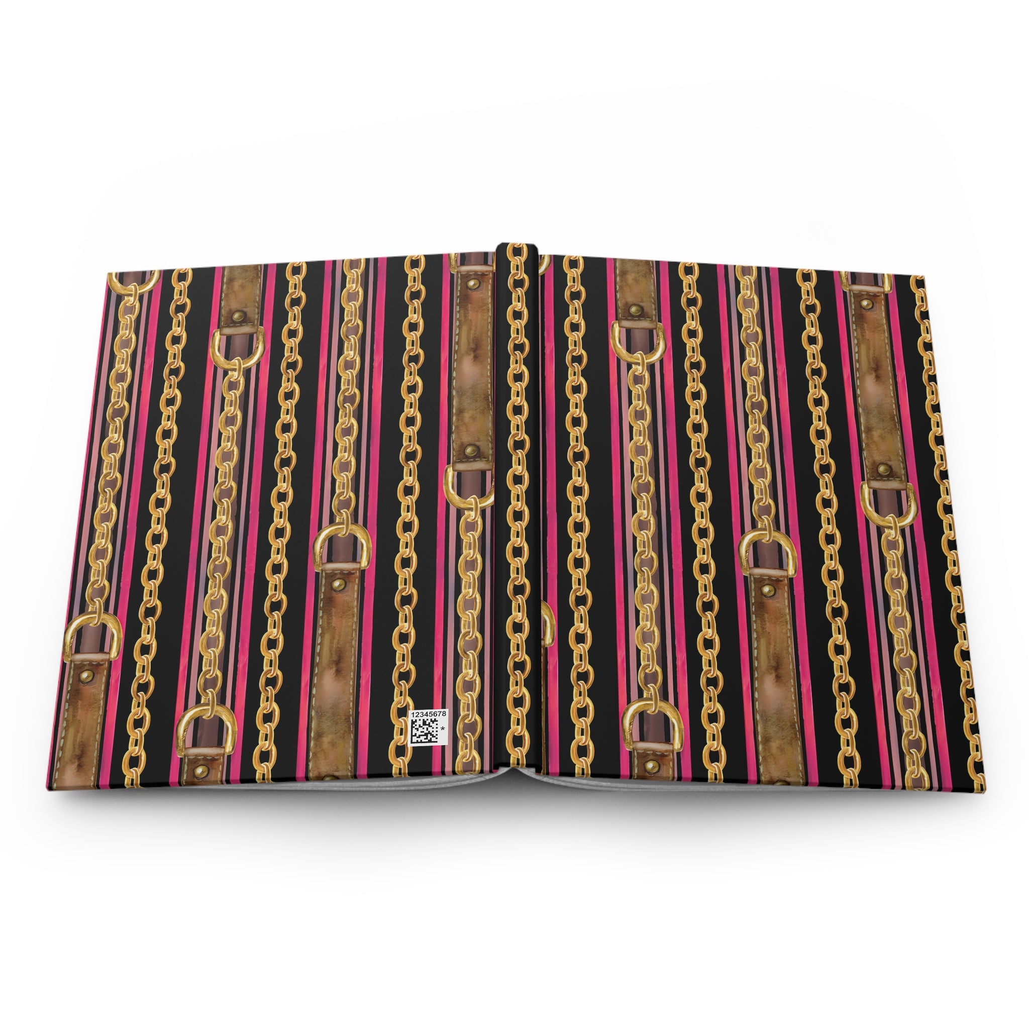 An open book or binder with a decorative cover pattern featuring vertical stripes of gold chains, brown faux-leather straps, and bright pink lines on a black background, photographed on a white studio background.