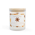 Candle with a label featuring cinnamon and star anise on a white background