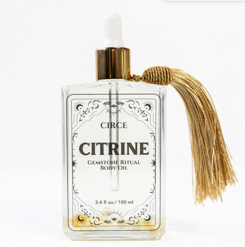 Circe Citrine body oil bottle with tassel on a white background