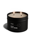 Black candle in a tin labeled 'Vineyard Estate' with a white lid on a transparent background