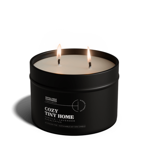 Black candle in a tin labeled 'Vineyard Estate' with a white lid on a transparent background
