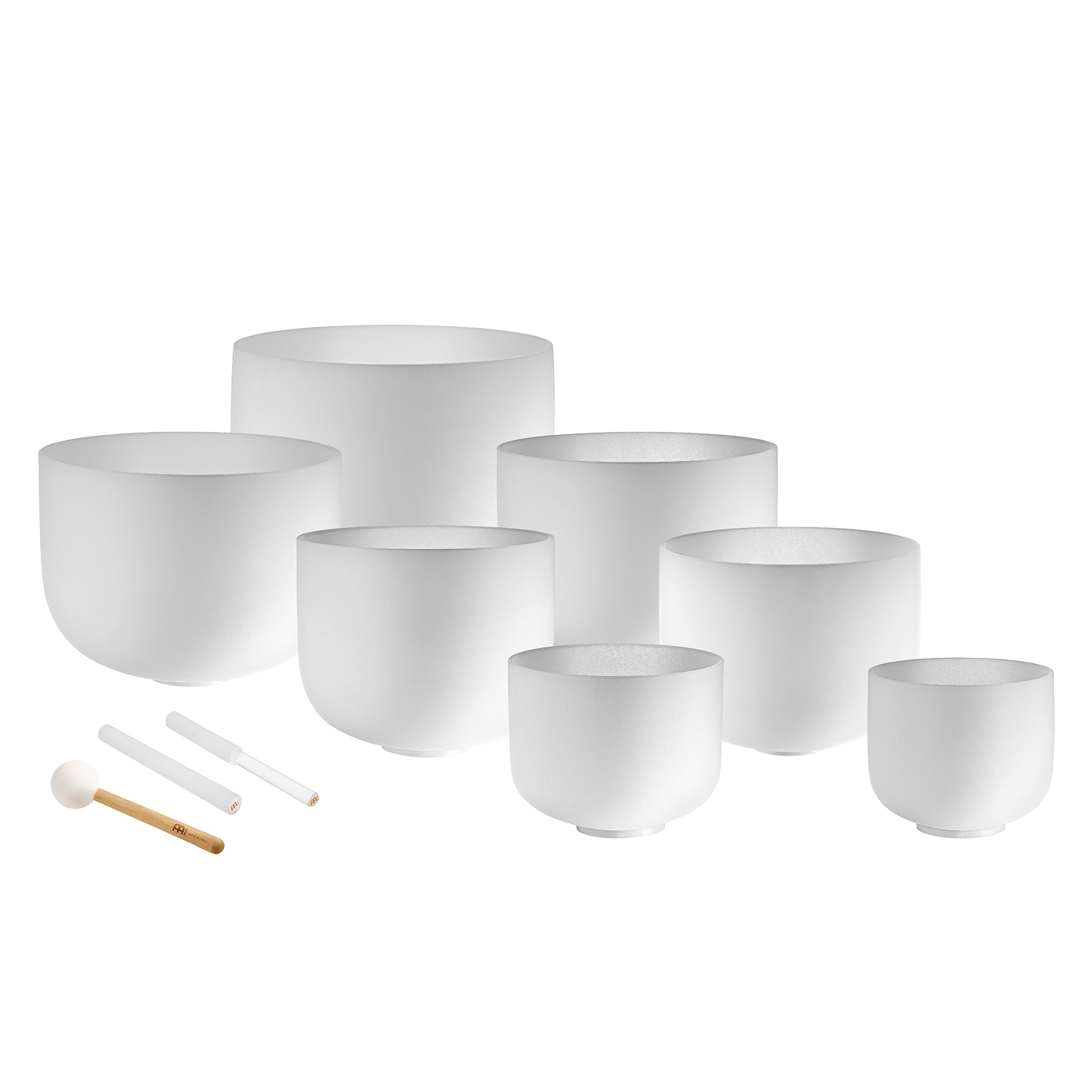 Set of white ceramic singing bowls with accessories on a dark blue background