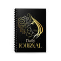 A black spiral-bound daily journal with a gold foil-style illustration of a woman's face surrounded by flowers and the words 'Daily JOURNAL' on the cover, shown on a plain white background.