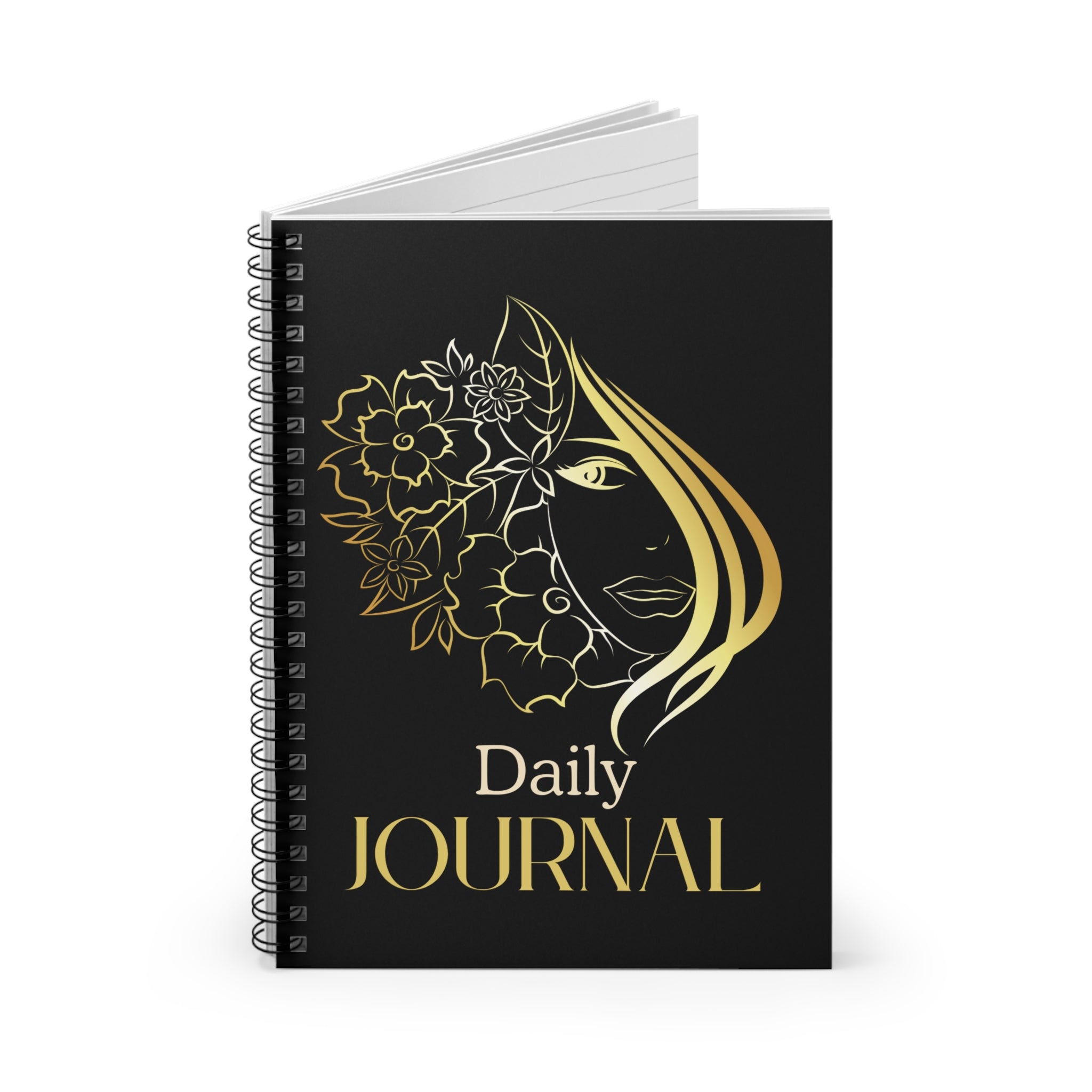 A black spiral-bound daily journal with a gold line-art illustration of a woman's face surrounded by flowers and the words 'Daily JOURNAL' in gold, shown on a clean white background.