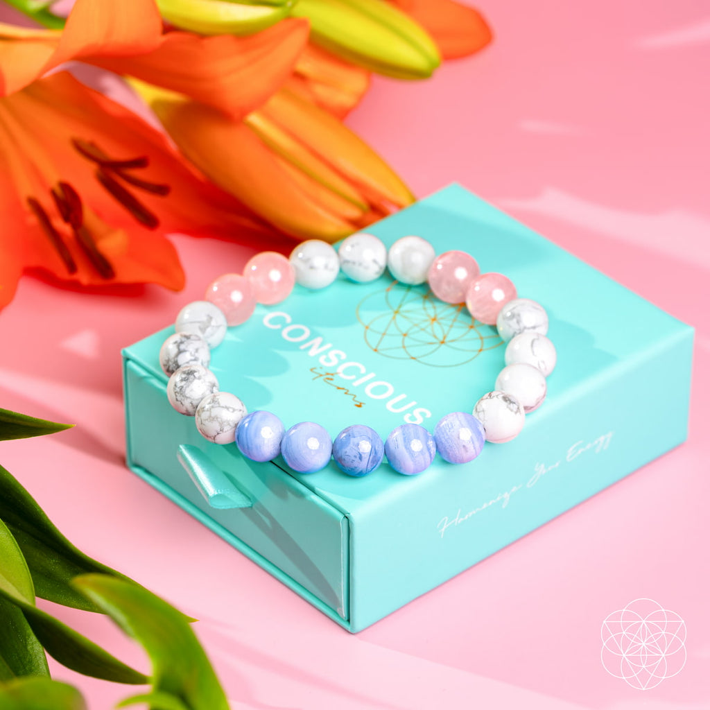 Colorful beaded bracelet on a turquoise box with flowers in the background