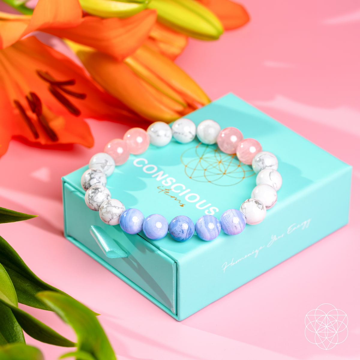 Colorful beaded bracelet on a turquoise box with flowers in the background