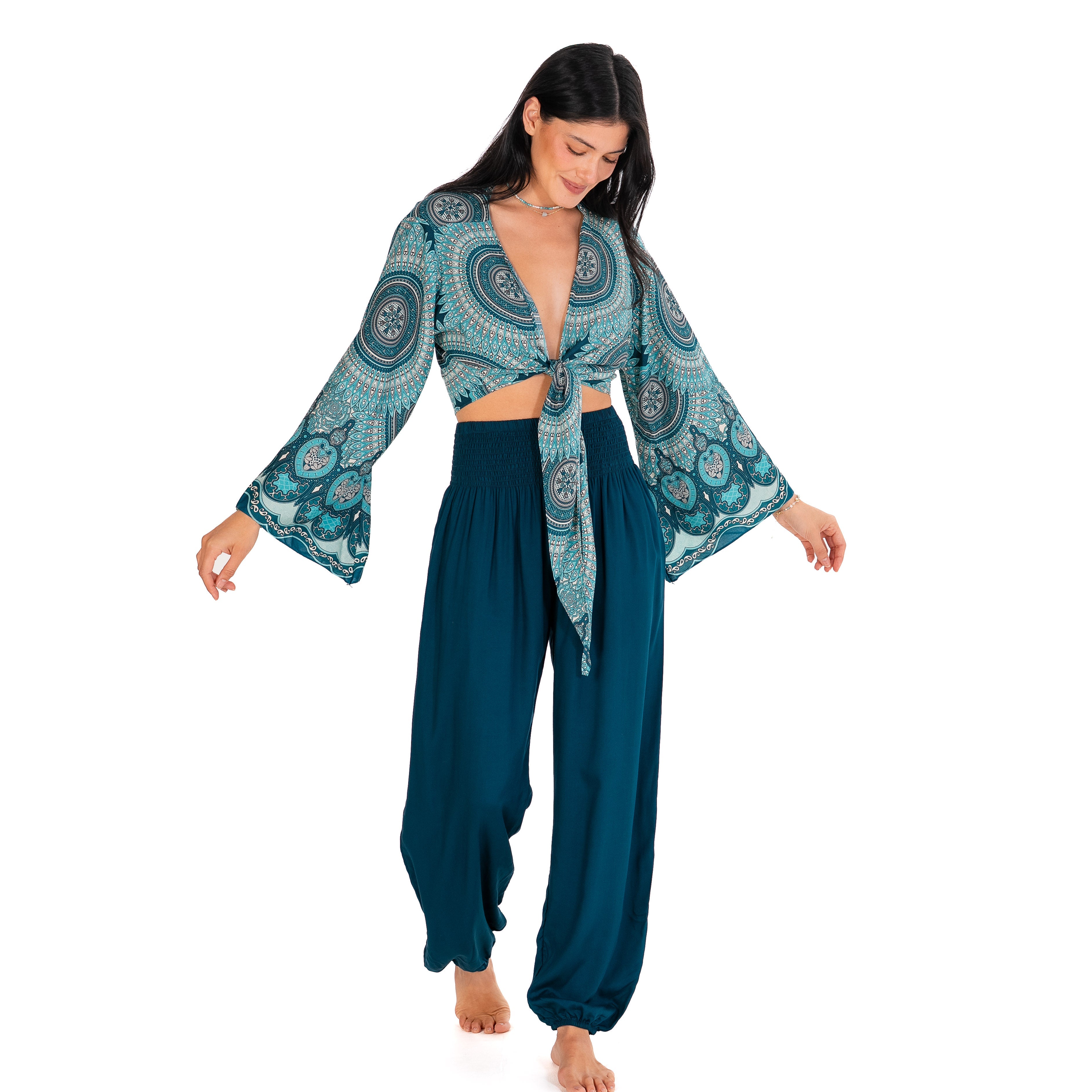 Woman wearing a blue and green patterned outfit on a white background
