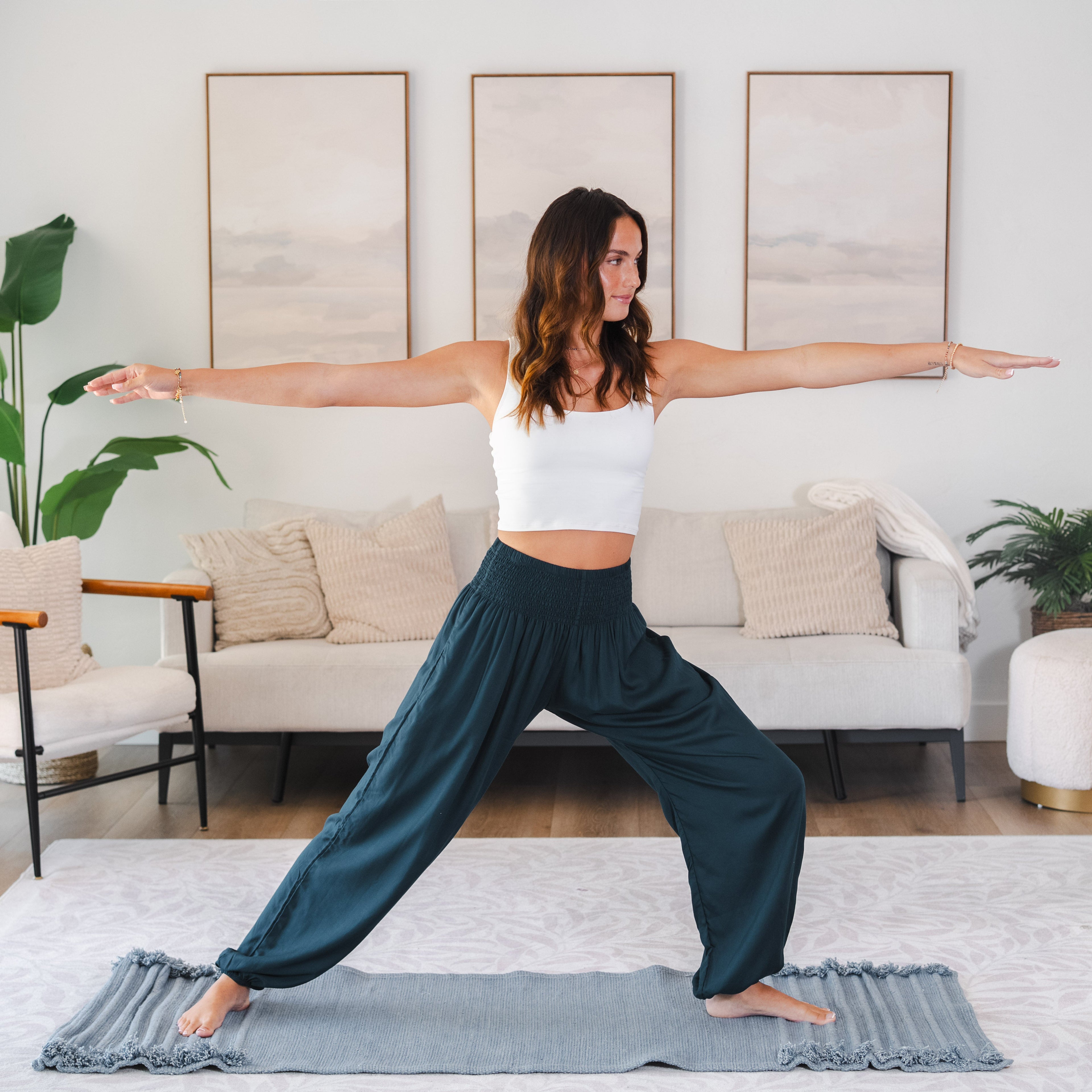 Woman practicing yoga in a living room with a neutral color palette