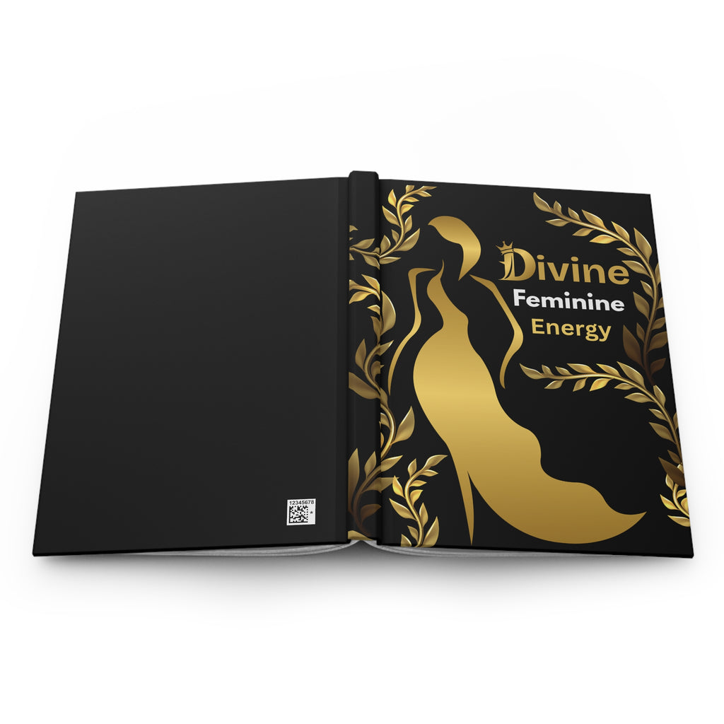 A black hardcover journal or book shown open, featuring a gold high-heel silhouette, gold laurel leaves, and the text 'Divine Feminine Energy' on the right page. A small square logo is visible near the bottom left of the left page.