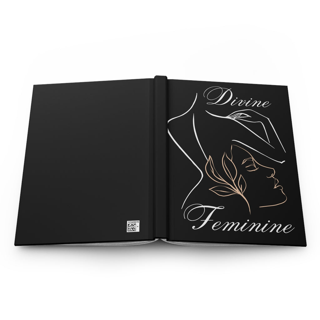 An open black journal or book with a minimalist line-art illustration of a woman's profile and the words 'Divine Feminine' in white and gold on the right page, shown on a clean white background.