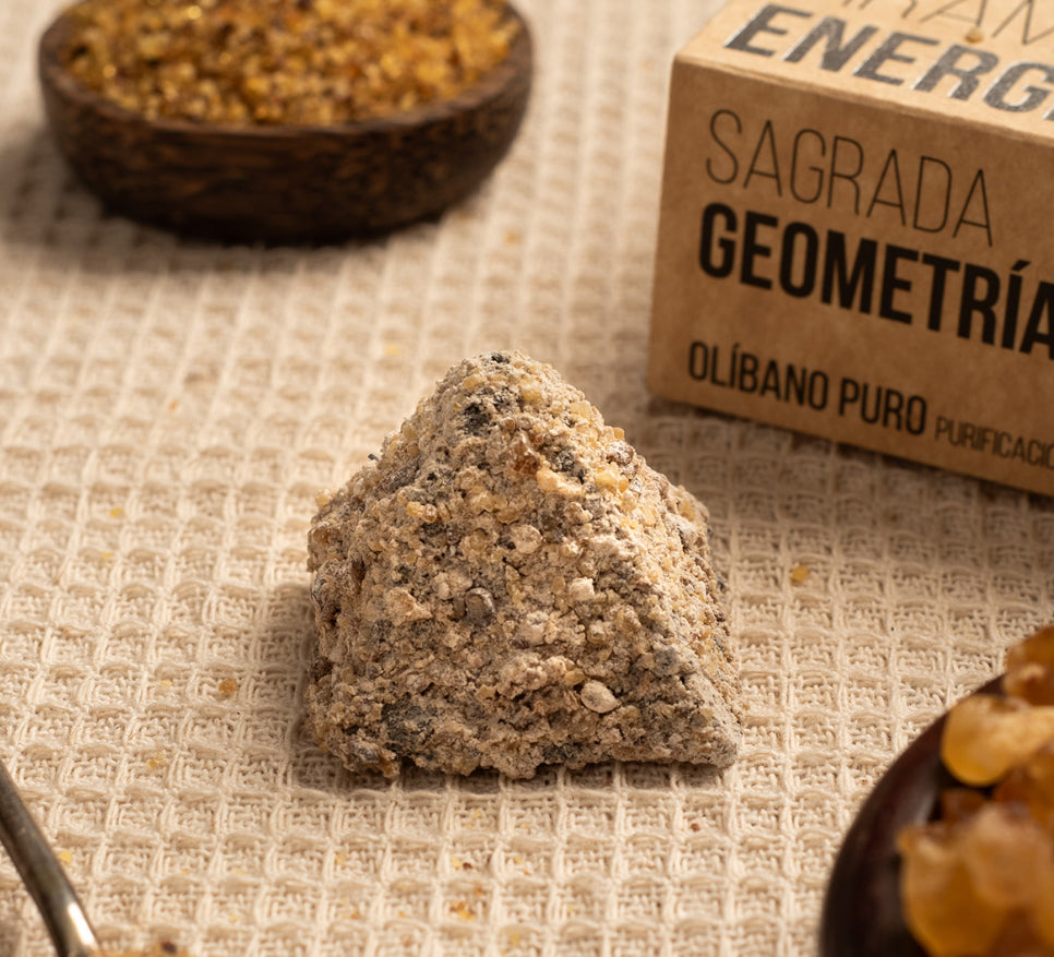 Mineral sample on a textured surface with 'Sagrada Geometria' packaging in the background