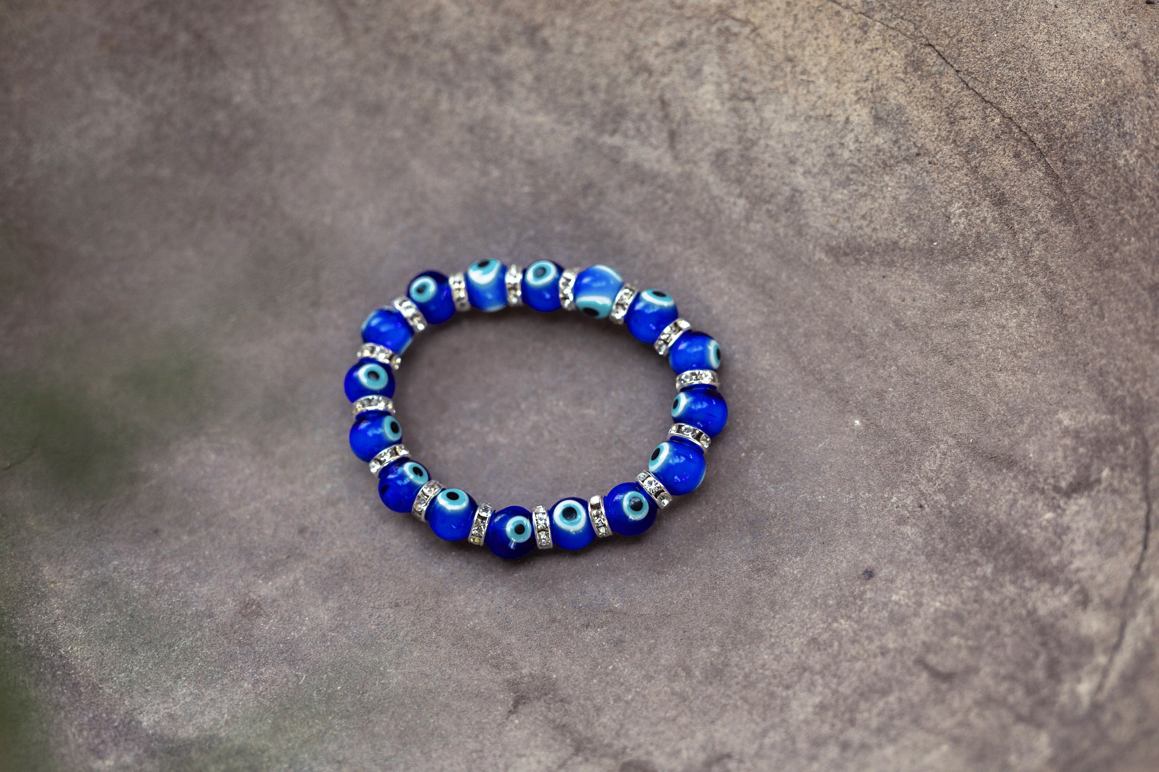 Blue beaded bracelet on a gray stone surface