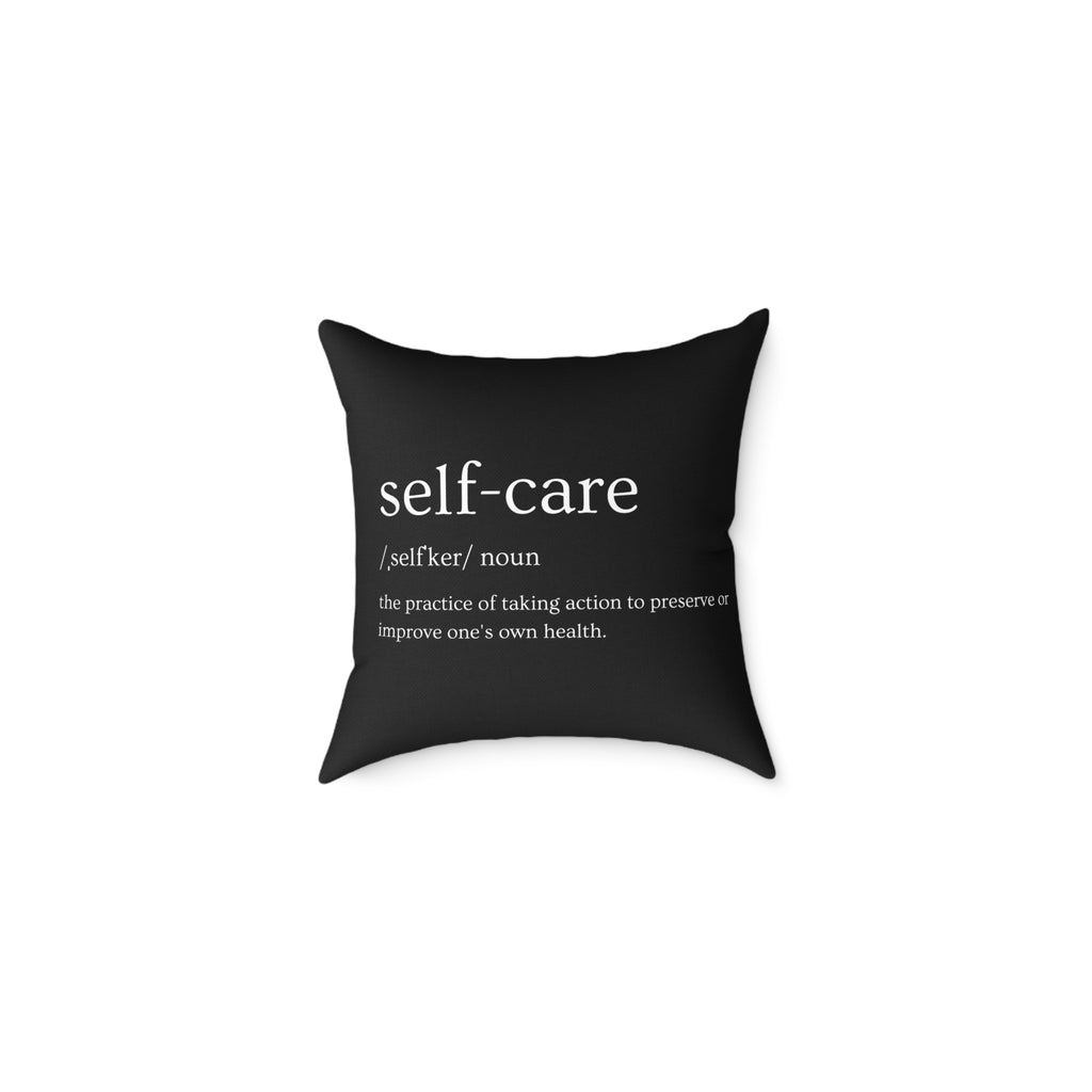 Black pillow with 'self-care' definition text on a white background