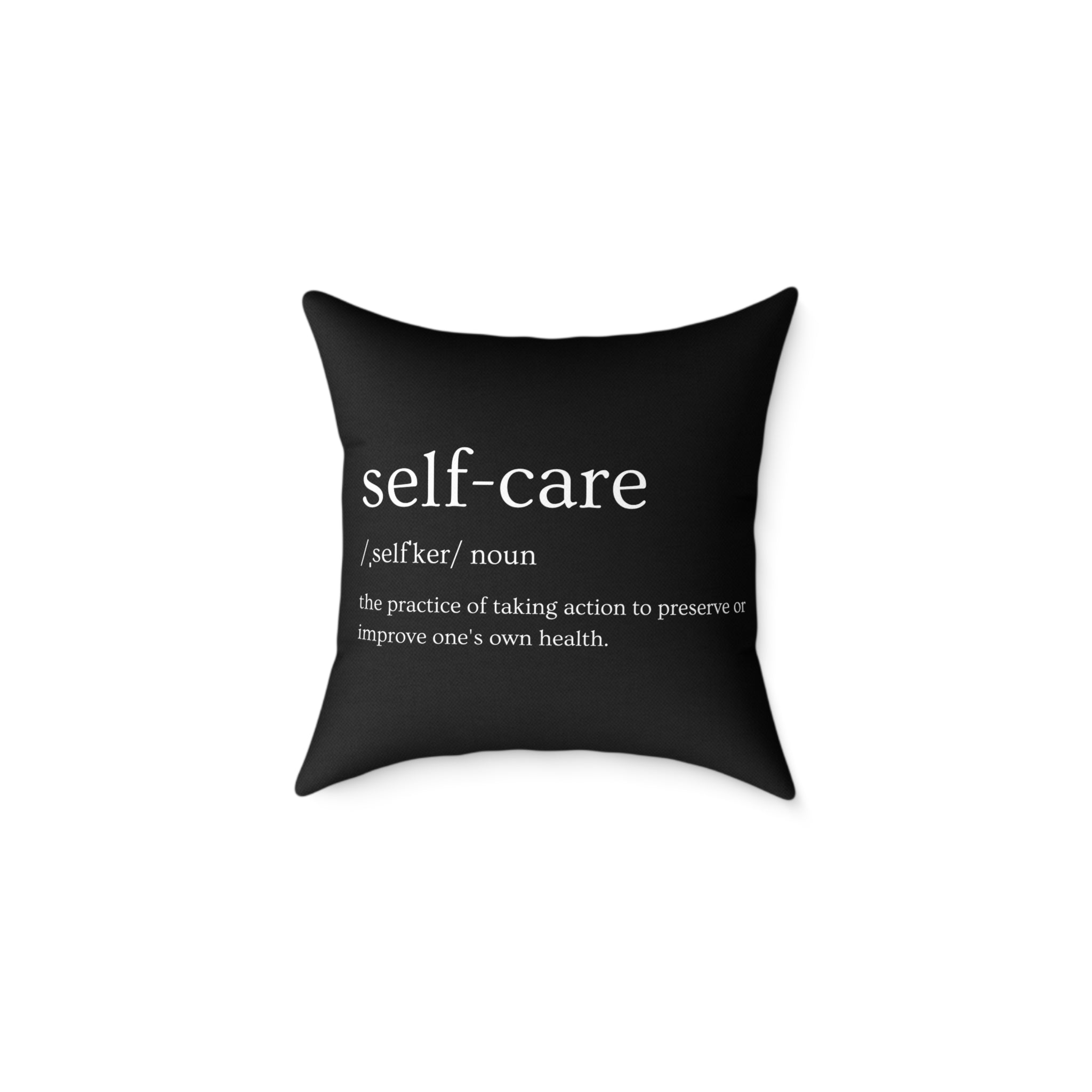 Black pillow with 'self-care' definition text on a white background