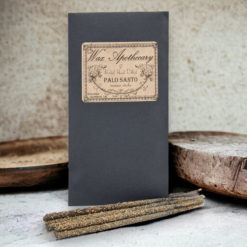 Wax Apothecary Palo Santo incense sticks with packaging on a textured surface