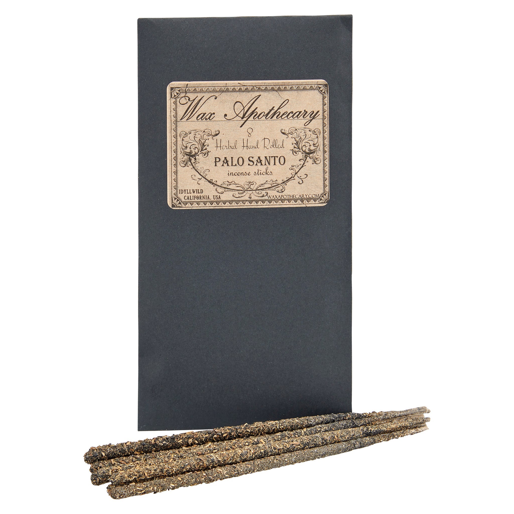 Black box with 'Wax Apothecary' label and three Palo Santo sticks on a white background