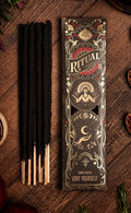 Incense sticks with decorative packaging on a wooden surface