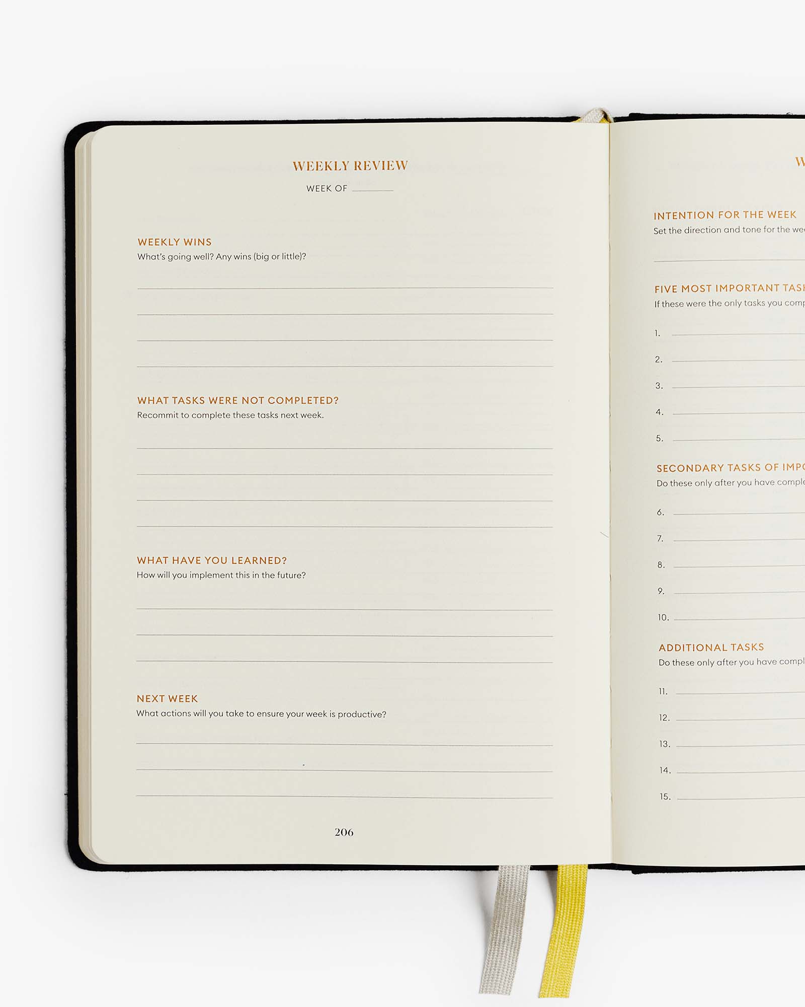 Open planner with weekly review section on a white background
